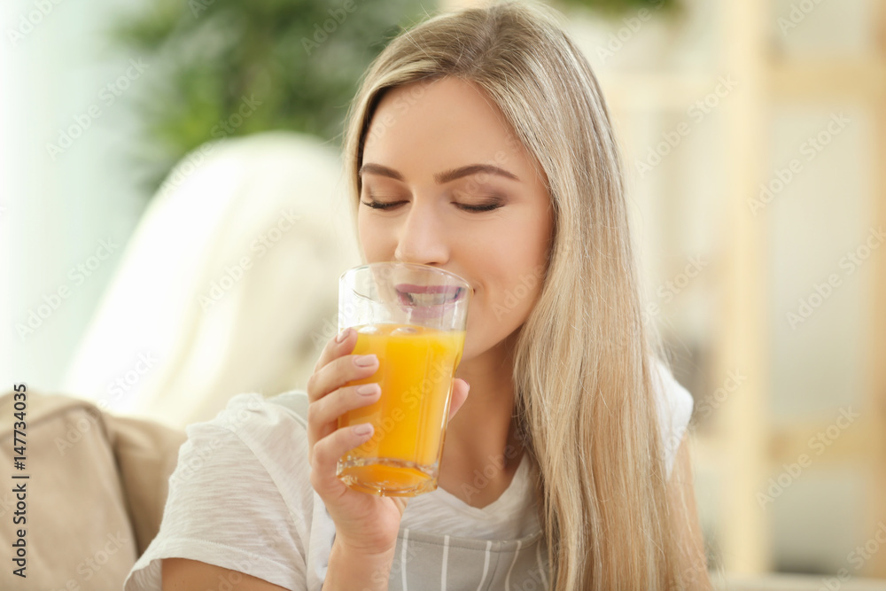 Beautiful young woman drinking fresh juice at home Beautiful young woman drinking fresh juice at home