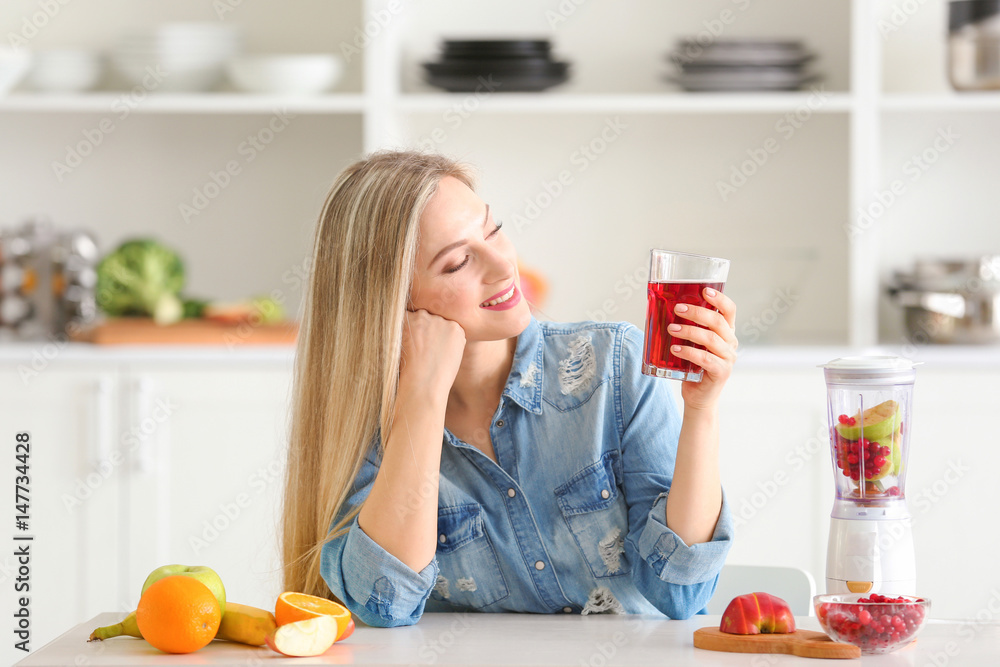 Beautiful young woman with glass of fresh juice in kitchen Beautiful young woman with glass of fresh juice in kitchen