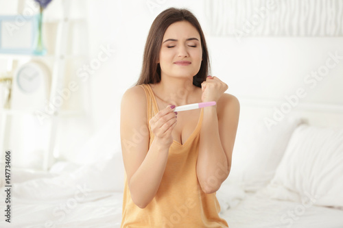 Happy young woman waiting f...