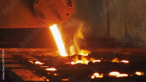 red-hot aluminium is pouring in black Trolleys, smelting shop in metallurgical factory, close-up