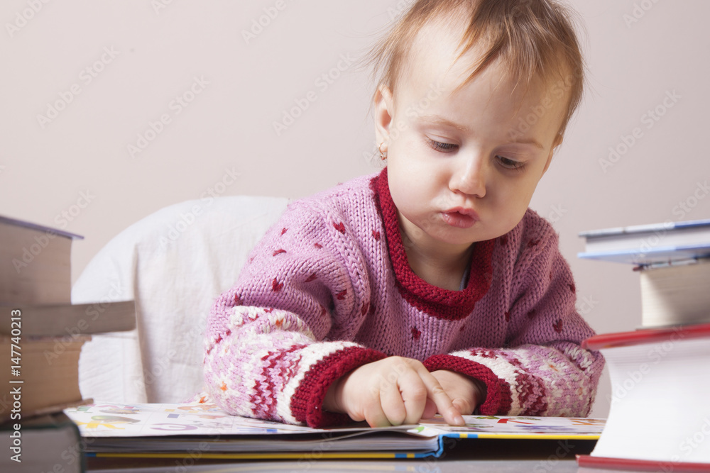 beautiful little child girl learns to read (success, education, development) beautiful little child girl learns to read (success, education, development)