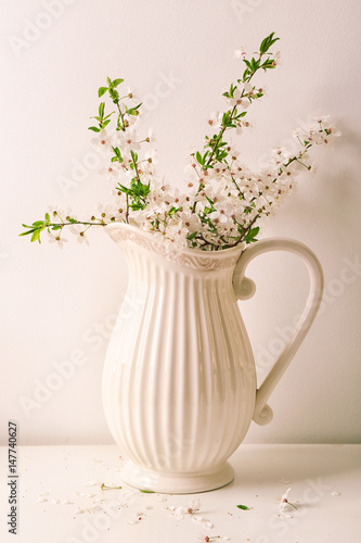 Wallpaper Mural Jug with blossoming spring branches on table Torontodigital.ca