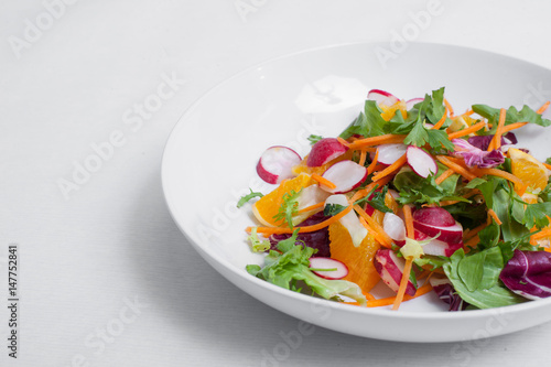 salad with radishes, carrots with greens;