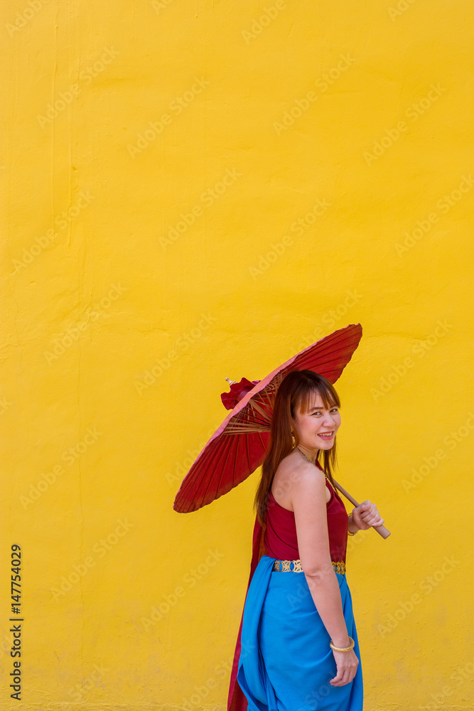Fototapeta premium girl in thai dress costume with umbrella