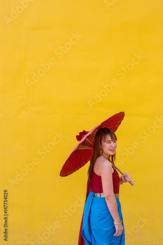 girl in thai dress costume with umbrella