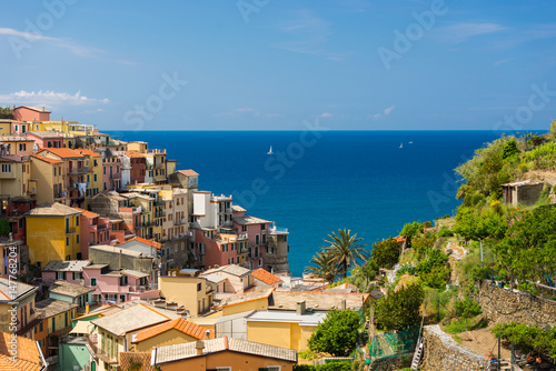 Colorfull Cinque Terre Manarola view with sailboats in sunny summer day in Italy