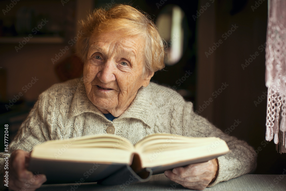 Retired old woman reading a book in your house. Retired old woman reading a book in your house.