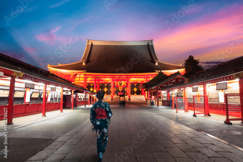 Japanese woman walking to pagoda, Tokyo Japan