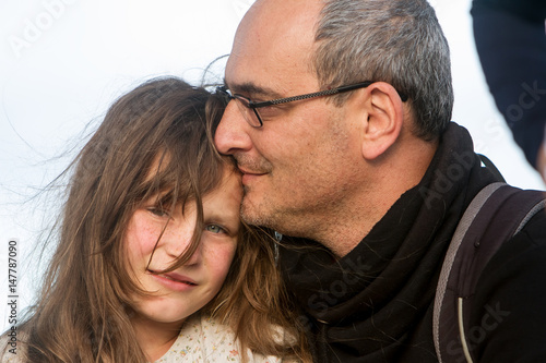 outdoor portrait of young child girl with her dad on natural background