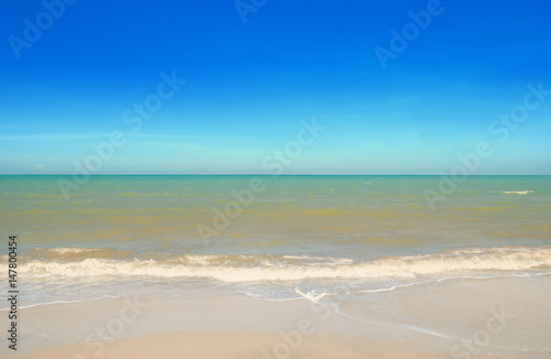 Wave & Sand beach with blue sky background 