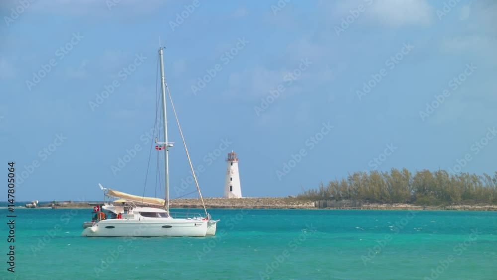 Nassau Bahamas Yacht in Tropical Bay with Vibrant Colors and the Landmark Lighthouse Background on a Sunny Day at the Island Nassau Bahamas Yacht in Tropical Bay with Vibrant Colors and the Landmark Lighthouse Background on a Sunny Day at the Island