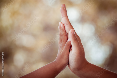 mother and child daughter making hi five gesture in vintage color tone © pingpao