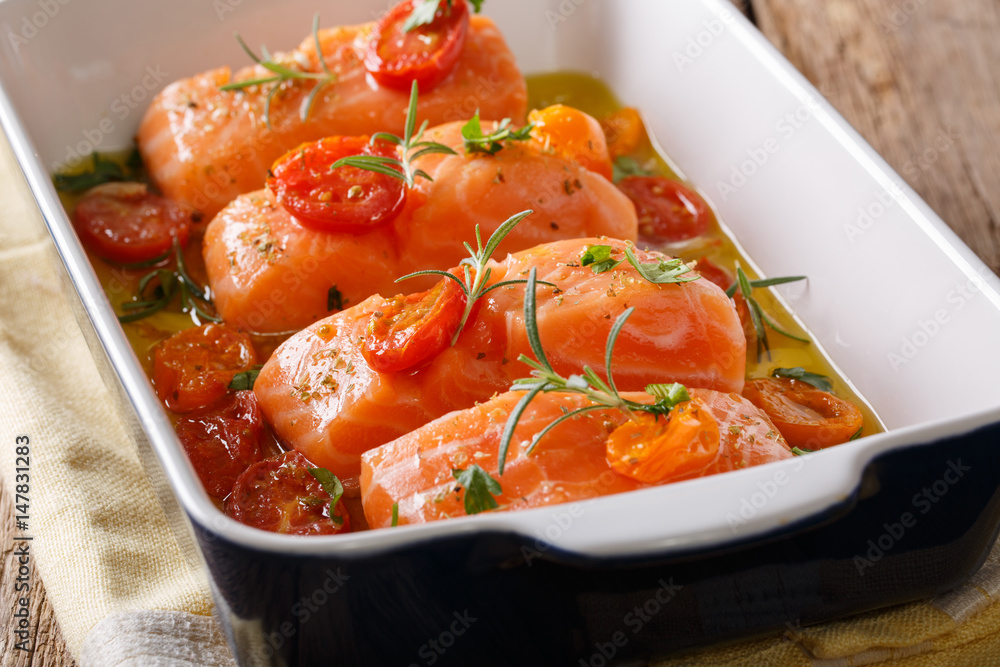 Slow Baked Salmon and Cherry Tomatoes in olive oil closeup. Horizontal