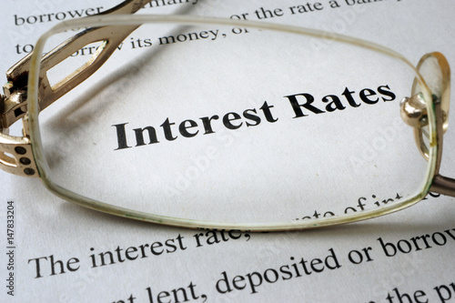 Page of paper with words interest rates and glasses.