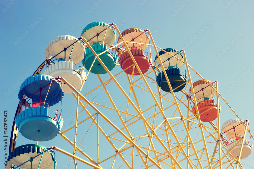 Ferris wheel-yellow with multi-colored booths