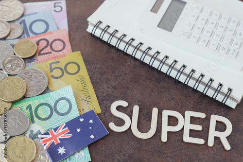 Australian money, AUD with SUPER word, calculator, and notebook, coronavirus stimulus package, superannuation concept photo