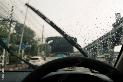 Windshield wipers from inside of car, season rain.