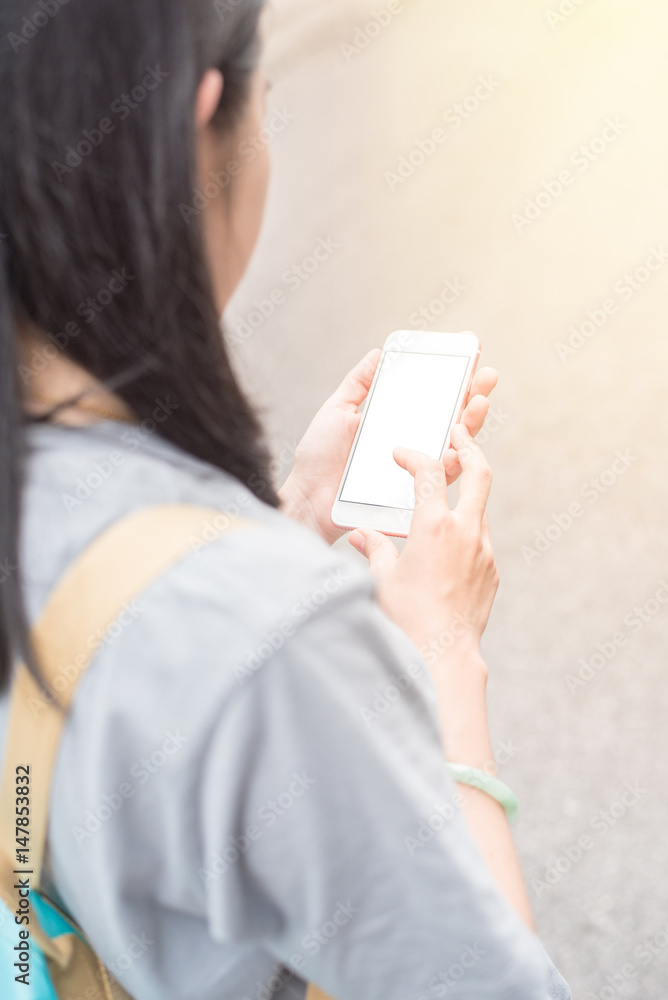 Young Asian traveling blogger or backpacker using route application on the mobile phone to find the needed address in a city phuket, Thailand. Young Asian traveling blogger or backpacker using route application on the mobile phone to find the needed address in a city phuket, Thailand.