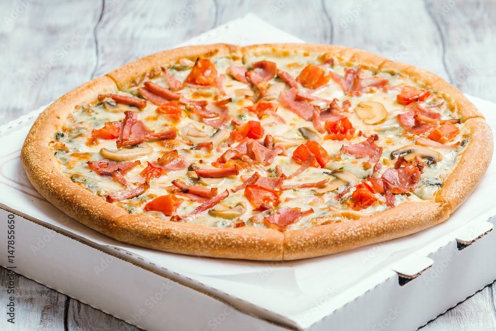 Delicious pizza with mushrooms and ham