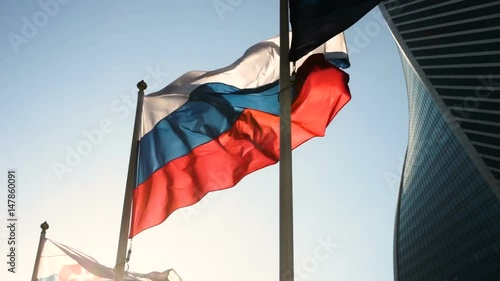 Close-up shot of flag of Russia in the wind on the background of Moscow City. HD photo