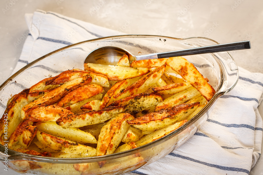 Homemade baked potatoes with spices in a glass form. Homemade baked potatoes with spices in a glass form.