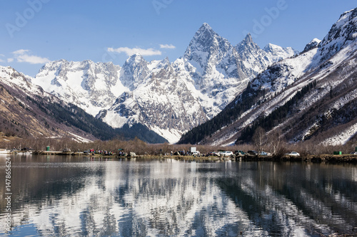 Lake and high mountains in clear weather, traveling and hiking.