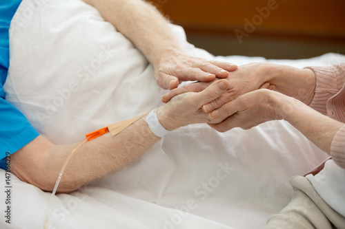 Wife with senior man in hospital