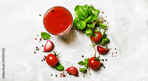 Food background, banner, tomato juice, green basil, cherry tomatoes, garlic, salt, spices. Top view, flat lay