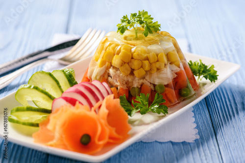 Aspic- jellied chicken with egg and vegetables. photo