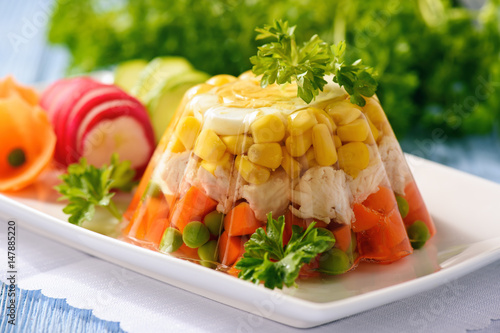 Aspic- jellied chicken with egg and vegetables. photo