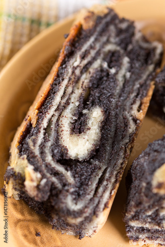 Poppy seed roll cake slices on the wooden background