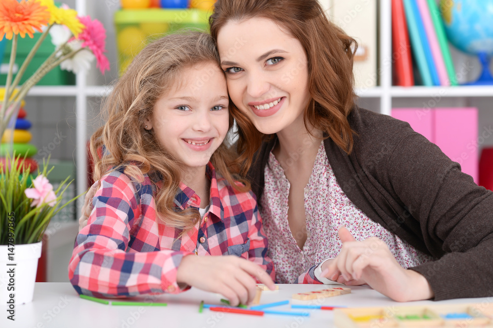 Mom and daughter are playing at the table Mom and daughter are playing at the table