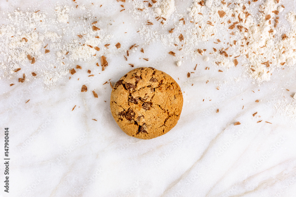 Chocolate chips cookie with flour on white marble