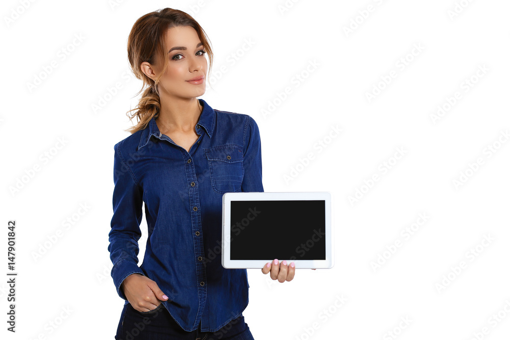 Copy space on her tablet. A cute young woman showing her digital tablet and smiling while standing on a white background Copy space on her tablet. A cute young woman showing her digital tablet and smiling while standing on a white background