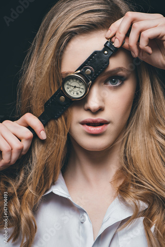 girl hiding eye with vintage watch