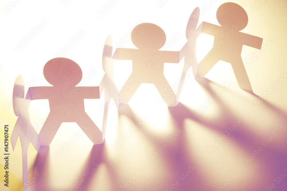 Paper chain team united together holding hands Paper chain team united together holding hands