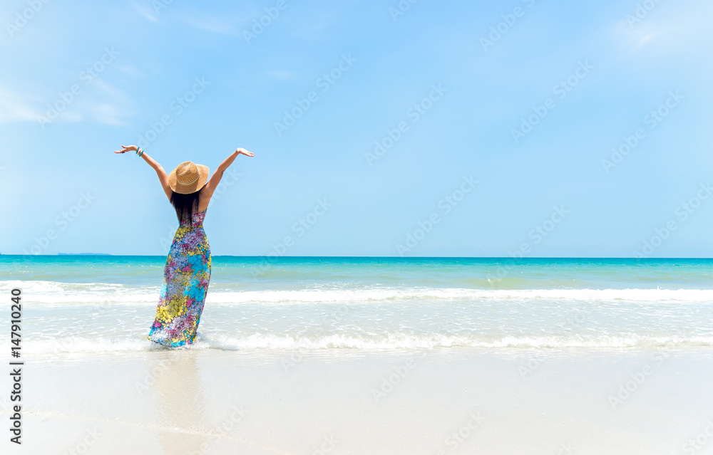 Happy woman on the beach in summer