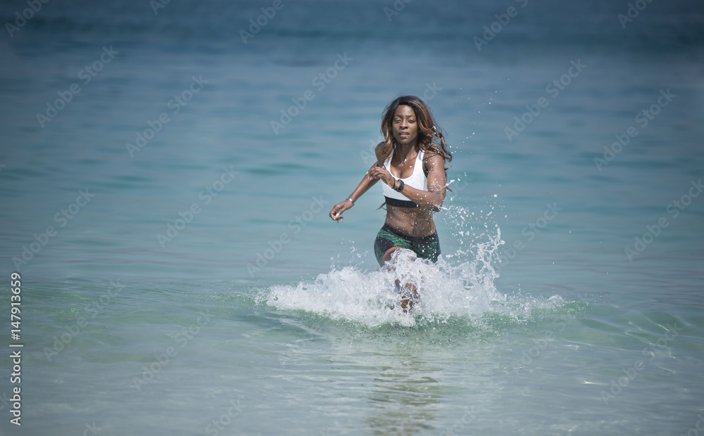 Beautiful African American Black athletic woman running out of the