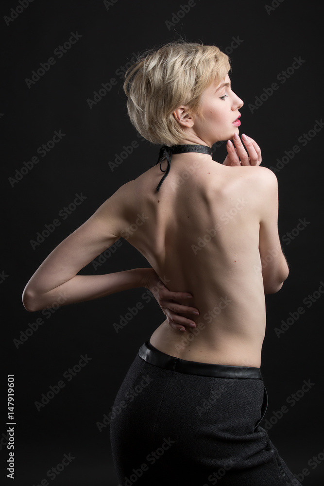 Kort levetid forklare Pinpoint Sexy naked young woman wearing black leather choker tied to the bow and  black skirt. Nude short hair blond. Isolated black background. Stock Photo  | Adobe Stock