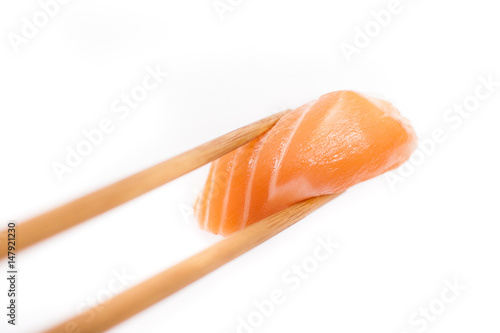 Salmon sushi nigiri isolate on white background. piece of sushi keep chopsticks