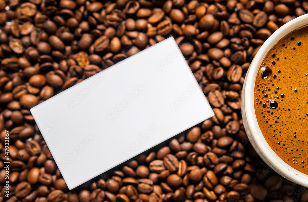Coffee cup and coffee beans on table, top view, love coffee, Brown coffee beans isolated on white background, Hot Coffee cup with Coffee beans Coffee cup and coffee beans on table, top view, love coffee, Brown coffee beans isolated on white background, Hot Coffee cup with Coffee beans
