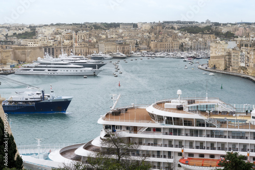 Cruise ship and yachts docked at the port of Malta photo