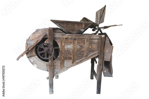Old rusted threshing machine isolated on white