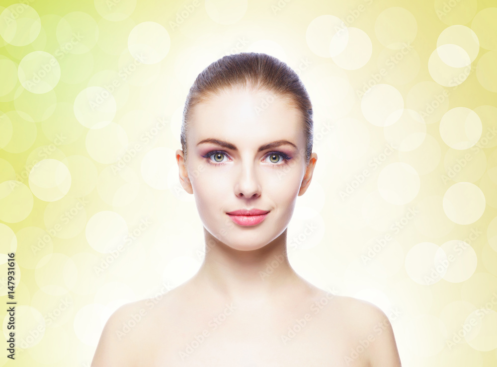 Naklejka premium Portrait of young, beautiful and healthy woman: over yellow background. Healthcare, spa, makeup and face lifting concept.