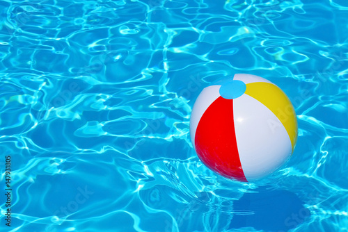 Colorful inflatable ball floating in swimming pool