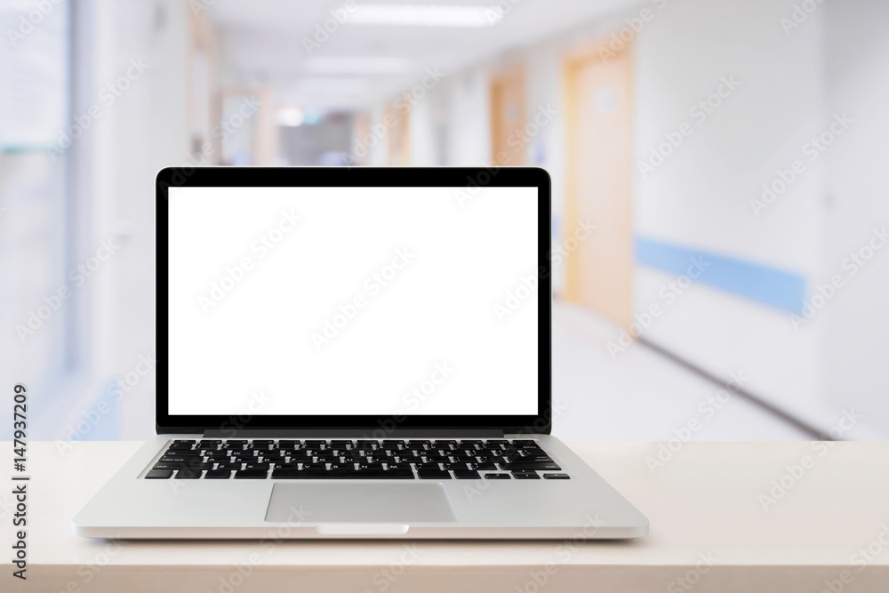 Laptop computer on medical table with hospital background Laptop computer on medical table with hospital background