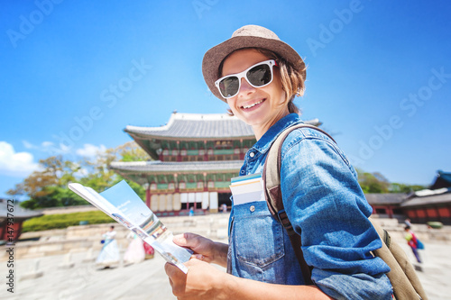 Photography Young woman tourist with map in hand on the background of Asian architecture, tr