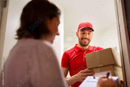 deliveryman and customer with parcel boxes at home