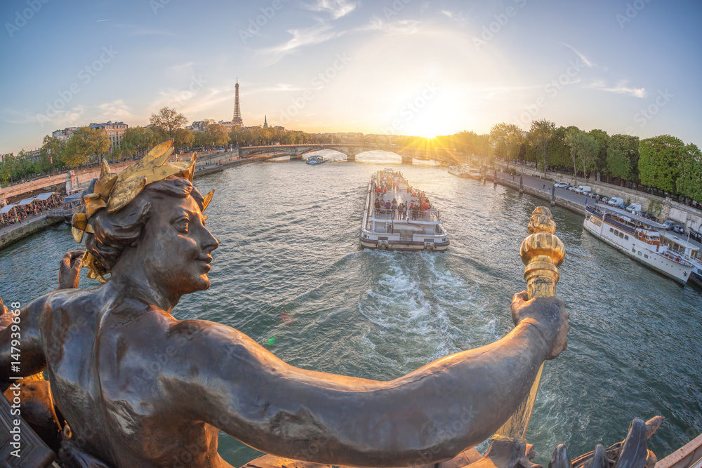 Fototapeta premium Alexandre III bridge in Paris against Eiffel Tower with boat on Seine, France