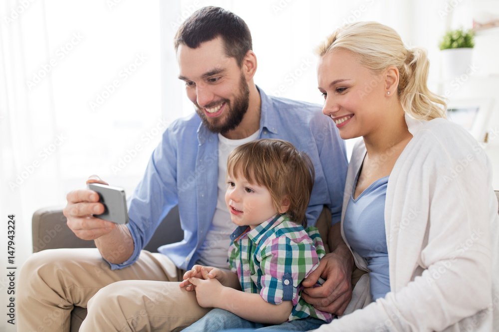 happy family with smartphone at home